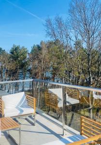 a balcony with chairs and a view of trees at Apartament Dwie Sosny Patrycja in Ustronie Morskie