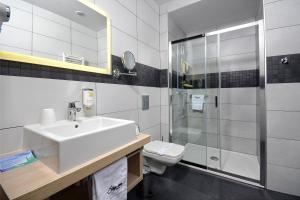 a bathroom with a sink and a toilet and a shower at Stay inn Hotel Gdańsk in Gdańsk