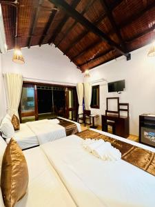 Postel nebo postele na pokoji v ubytování The Poplar Resort Phú Quốc
