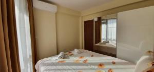 a bedroom with a bed with flowers on it at Luxury Apartments Ekaterina in Chernomorets