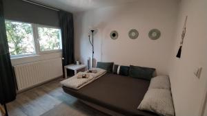 a living room with a couch and a window at Flóra House 3 minutes from Lake Balaton in Keszthely