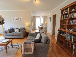 a living room with a couch and a book shelf at Silver Birches in Windermere