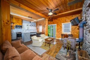 a living room and kitchen in a log cabin at Mountain Treasure Bed and Breakfast in Maplecrest