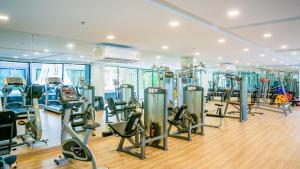 a gym with a bunch of treadmills and ellipticals at The Star Hill Condo Luxury Suites in Chiang Mai