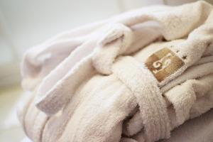 a white towel with a tag on it at Hotel La Pigna in Marina di Pietrasanta