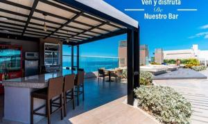 a kitchen and dining area with a view of the ocean at Luxury Aparment in Reserva del Mar in Gaira