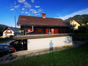 a shadow of a person on a wall in front of a house at Hiška pr Bohinjski mami in Bohinj
