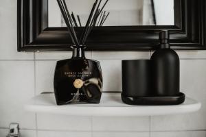 a bottle of soap and a candle on a shelf at Boutique Hotel Cologne in Cologne