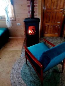 a living room with a chair and a stove at Durmitor Chill Chalet in Žabljak