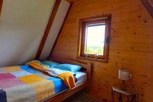 a bedroom with a bed in a log cabin at Durmitor Chill Chalet in Žabljak