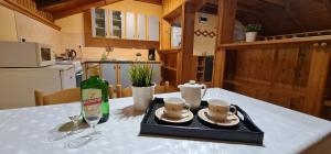 a table with a bottle of wine and two glasses at Apartment TRIO FANTASTICO in Podaca