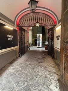 an entrance to a building with an iron gate at Two Rooms Chiaia 37 in Naples