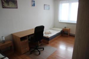 a bedroom with a desk and a bed and a chair at Prázdninové ubytování - celý byt jen Váš in Litomyšl