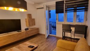 a living room with a flat screen tv and a couch at QR Apartment for Family, Couples, and Friends stay in Rijeka in Rijeka