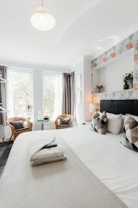 une chambre avec un grand lit blanc et un salon dans l'établissement Sweet Suites Lytham, à Lytham St Annes