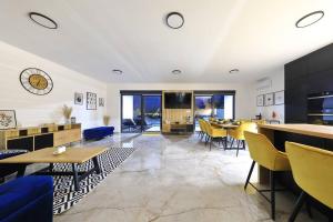 ein Esszimmer mit Tischen und gelben Stühlen in der Unterkunft Villa Good Vibes with heated pool in Vrsi