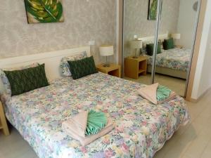 una camera da letto con letto, cuscini e specchio di T2 de luxo em Albur-VIllage a 10 minutos da praia a pé ad Alvor Altre 74 foto