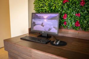 ein Computermonitor, eine Tastatur und eine Maus auf dem Schreibtisch in der Unterkunft Hotel Colonial Ciudad Juarez in Ciudad Juárez