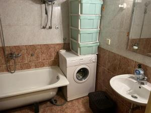 a bathroom with a washing machine and a sink at Apartments Bella in Kotor