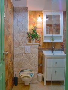 a bathroom with a toilet and a sink at SWEET SMILE in Postira