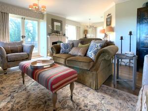 a living room with a couch and a table at The Gatehouse - UK36939 in Lamerton