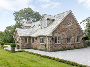 a brick house with a gambrel roof at The Gatehouse - UK36939 in Lamerton