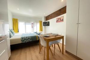 a bedroom with a desk and a bed and a table at Coeur Massy M10 Rer BC 600m - Orly20 min in Massy