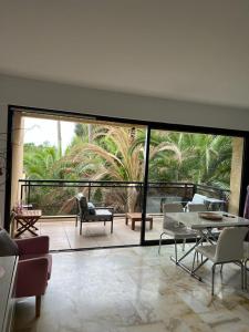 a living room with a large glass door with a patio at Cannes Eden résidence de luxe piscine tennis in Vallauris