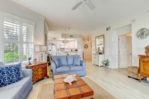 a living room with a blue couch and a table at Ocean Place Condo in Amelia Island