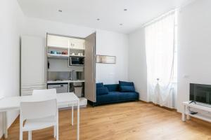 a living room with a blue couch and a table at ~ Cozy Apartment ~ City Center [Train Station] in Trieste
