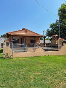 a small house with a gate in front of it at Xristos Villa in Nea Vrasna