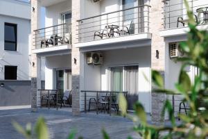 a building with chairs and tables on the balcony at Apartments Ali in Ulcinj