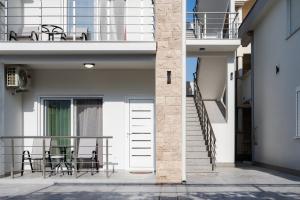 a white building with a door and a balcony at Apartments Ali in Ulcinj +26 photos
