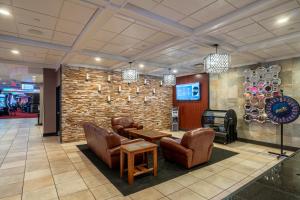 a lobby with leather chairs and a stone wall at Grand Z Hotel Casino by Red Lion Hotels in Central City