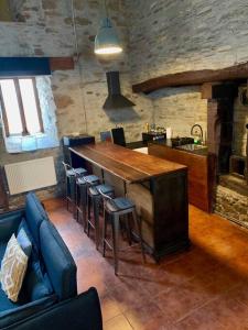 a kitchen with a bar with stools in a room at Mirador Yellow Door in Ponferrada