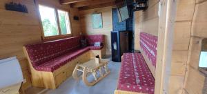 a train room with a red bench and a table at Chalet La Trouvaille in Thollon