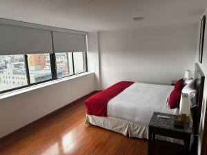 a bedroom with a bed and a large window at Hotel Oceanía Bogotá Museo in Bogotá +23 photos