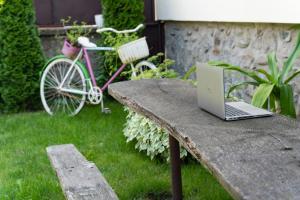 a laptop computer sitting on a stone bench with a bike at Siebenbürger Haus in Sibiu