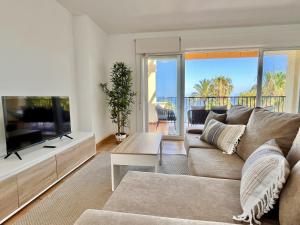 a living room with a couch and a flat screen tv at Mar y Montana House by Gloove in Altea