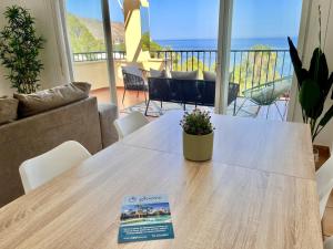 a table in a living room with a book on it at Mar y Montana House by Gloove in Altea la Vieja