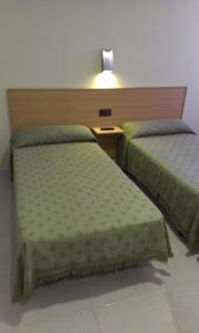 two beds sitting next to each other in a room at Hostal Bisbal ONLY ADULTS NO AC in Valencia +48 photos