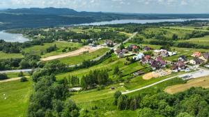 an aerial view of a village on a hill next to a lake at BIWAK Na Sygulnej Przywieź namiot in Mizerna