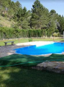 a golf course with a blue pool of water at Casa Rural Riópar, luxury in nature in Riópar