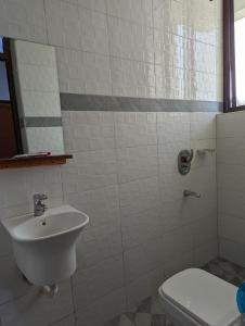 a bathroom with a sink and a toilet at Success Apartments - Silver in Mwanza