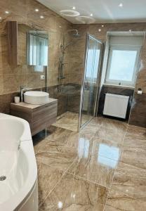 La salle de bains est pourvue d'un lavabo, d'une douche et de toilettes. dans l'établissement Apartmani LU&LO, à Delnice