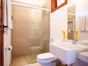 a bathroom with a sink and a toilet and a shower at MKNI Hotel - Ikaika Makani Experience in Prea