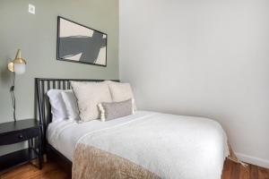 a bedroom with a bed and a mirror on the wall at Well-located S Boston 1BR on E Broadway BOS-473 in Boston
