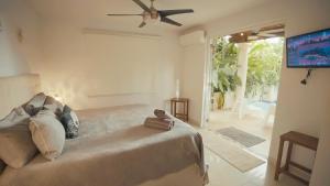 a bedroom with a bed with a ceiling fan at Relaxing Oasis with Pool heater and Cabana in San Juan