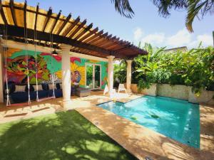 a house with a swimming pool in the yard at Relaxing Oasis with Pool heater and Cabana in San Juan