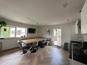 a large kitchen with a wooden table and chairs at Ferienhaus Goldene Zehn 